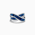 The Royale Bleu 14K White Gold Blue Sapphire and Diamond Crossover Ring features a crisscross design with rows of rectangular blue sapphires bordered by sparkling white diamonds.