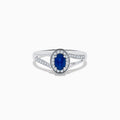 The Royale Bleu 14K White Gold Sapphire and Diamond Ring, 0.70 TCW, showcases an oval sapphire center with a diamond halo and a split shank band set with sparkling diamonds.