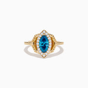 The 14K Yellow Gold Blue and White Diamond Marquise Ring features a striking blue and white diamond centerpiece, accented by a halo of round white diamonds and detailed band craftsmanship.
