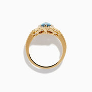The 14K Yellow Gold Blue and White Diamond Marquise Ring features a striking blue and white diamond centerpiece, accented by a halo of round white diamonds and detailed band craftsmanship.