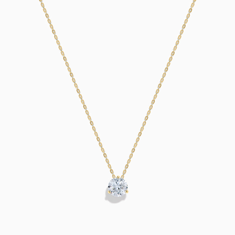 The Lab Grown Diamond Earring and Necklace Set in 14K Yellow Gold features a round diamond pendant and matching gold stud earrings, each showcasing a single round lab grown diamond, displayed on a white background.