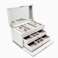The Jewelry Box - White features sturdy wood construction, a mirrored hinged lid, cushioned sections for rings and watches, two open drawers with multiple compartments, all lined with light beige fabric. Compact dimensions for convenient storage.