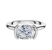 A platinum engagement ring with a half bezel east/west cathedral dome design and 2.0mm band, featuring a large oval-cut diamond in a modern minimalist setting against a plain white background.