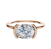 A 14K rose gold Bezel Half Bezel East/West Classic Dome 1.5mm engagement ring is displayed on a plain white background.