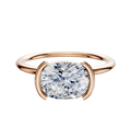 An 18K rose gold Bezel Half Bezel East/West Classic Dome 1.5mm engagement ring, shown with a cushion-cut diamond in a modern setting on a plain white background.