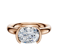 The 18K Rose Gold Bezel Half Bezel East/West Classic Dome 3.0mm Engagement Ring features a thick band and a large, horizontally set diamond in a modern bezel setting, shown against a plain white background.