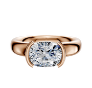 An 18K rose gold Bezel Half Bezel East/West Classic Dome 4.0mm engagement ring is shown against a white background, featuring a cushion-cut diamond set with two curved prongs on each side.