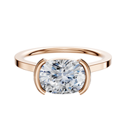 The 14K Rose Gold Bezel Half Bezel East/West Cathedral Flat 1.5mm Engagement Ring showcases a modern cushion-cut diamond in a bezel setting, elegantly presented against a plain white background.