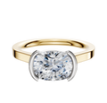 An 18K two-tone bezel half bezel East/West cathedral flat 2.0mm engagement ring with a large cushion-cut diamond set in four white metal prongs, displayed on a plain white background.