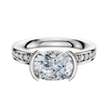 The 14K Two Tone Bezel Half Bezel East/West Classic Flat 1-Row-Pave 2.5mm Engagement Ring features a classic design with a central diamond set east-west in a half bezel, accented by a row of pave-set diamonds along the flat band.