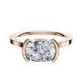 A 14K rose gold Bezel Half Bezel East/West Classic Flat 1.5mm engagement ring is displayed on a plain background.