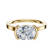 An 18K yellow gold Bezel Half Bezel East/West Classic Flat 2.0mm engagement ring featuring a large, cushion-cut diamond in a modern bezel setting, shown against a plain white background.