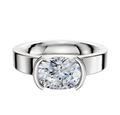 An 18K white gold half bezel East/West classic flat 4.0mm engagement ring featuring a large, oval-cut diamond in a modern bezel setting, shown against a plain white background.
