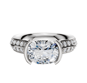 A 14K white gold engagement ring featuring a cathedral knife edge design with a bezel-set center and a single row of pave diamonds along the band.