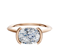 An 18K Rose Gold Bezel Half Bezel East/West Cathedral Knife Edge 1.5mm Engagement Ring is displayed on a plain white background.