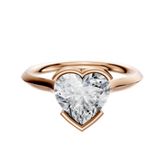 An 18K rose gold bezel half bezel east/west cathedral knife edge 2.0mm engagement ring is shown on a plain white background.