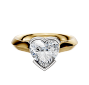 An 18K two-tone bezel half-bezel east/west cathedral knife edge 3.0mm engagement ring is shown on a plain white background, featuring a unique setting that blends gold and silver tones for an elegant look.