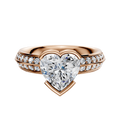 The 14K Rose Gold Bezel Half Bezel East/West Classic Knife Edge engagement ring features a 2.5mm band with a single row of pave diamonds for classic elegance.