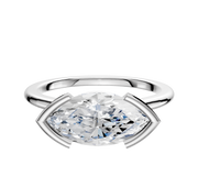 An 18K white gold engagement ring showcases a 1.5mm cathedral dome band with an east/west half bezel setting, displayed against a plain white background.