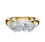 The 18K Two Tone Bezel Half Bezel East/West Cathedral Dome 4.0mm Engagement Ring features a modern, horizontally set clear gemstone in a sleek silver and gold setting, displayed against a plain white background.