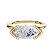 An 18K yellow gold Bezel Half Bezel East/West Classic Dome 2.0mm engagement ring featuring a horizontally set marquise-cut diamond in a modern setting, photographed against a plain white background.