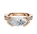 The 14K Rose Gold Bezel Half Bezel East/West Classic Flat 1-Row-Pave 2.5mm Engagement Ring features a central marquise-cut diamond and small round pave diamonds set along the band.