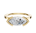 An 18K yellow gold engagement ring, featuring a flat 1.5mm band and a classic half bezel east/west setting, displayed against a plain white background.