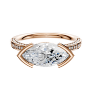 This 18K rose gold engagement ring features an east/west bezel-set center stone and a classic flat band with three rows of 2.0mm pave diamonds, combining modern elegance with sparkling accent stones.