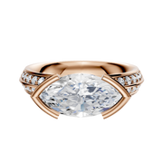 A 14K rose gold engagement ring featuring a classic knife edge and east-west bezel setting, highlighted by a single row of pave diamonds along the 2.5mm band.