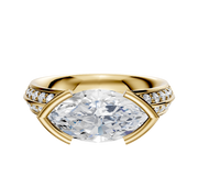 The 14K Yellow Gold Bezel Half Bezel East/West Classic Knife Edge Engagement Ring features a 2.5mm center stone and a single row of pave diamonds along the band for an elegant, symmetrical look with a polished finish.