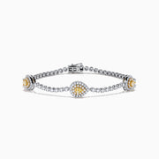 The 18K Two Tone Gold Yellow and White Diamond Bracelet features alternating round white stones and three central yellow diamond clusters, each encircled by white diamonds, secured with a reliable clasp.