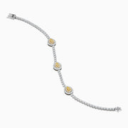 The 18K Two Tone Gold Yellow and White Diamond Bracelet features alternating round white stones and three central yellow diamond clusters, each encircled by white diamonds, secured with a reliable clasp.