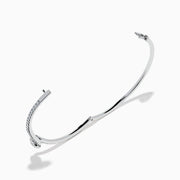 The Star Lab Grown Diamond Connect Bangle in 18K White Gold features a central round lab-grown diamond and a band set with small diamonds, all in an elegantly curved design, displayed on a white background.