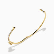 The Star Lab Grown Diamond Connect Bangle in 18K Yellow Gold features a central Star Lab Diamond with a row of smaller diamonds on an angled band, shown against a white background.