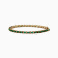 The Brasilica 14K Yellow Gold Emerald and Diamond Tennis Bracelet features a row of green emeralds and sparkling diamonds set in yellow gold prongs, shown against a plain white background.