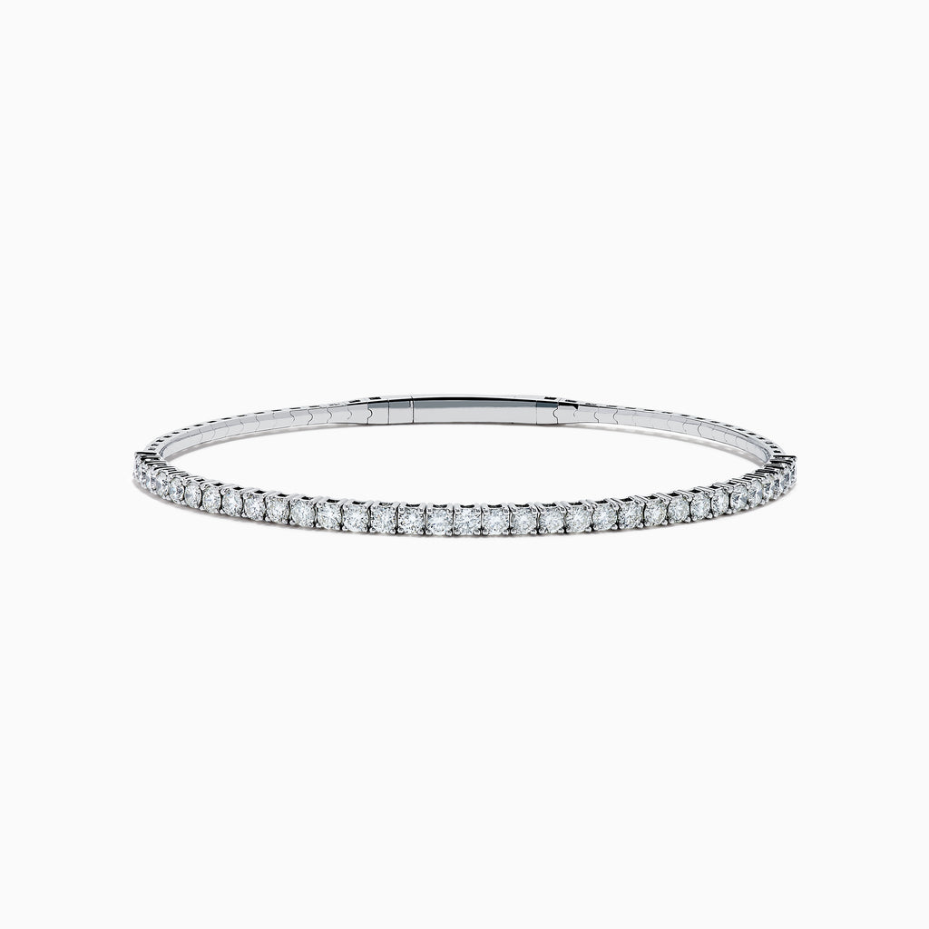 The 14K White Gold Flexible Diamond Bracelet features a slim, elegant design with a single row of sparkling diamonds set around its flexible band, shown against a white background.