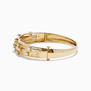 The D'oro 14K Yellow Gold Interwoven Crossover Bangle features multiple slim, interlaced bands adorned with evenly spaced round white gemstones, set in yellow gold for a radiant look.