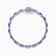 The 14K White Gold Tanzanite and Diamond Tennis Bracelet features alternating oval tanzanite gemstones and sparkling diamonds set against a plain white background.