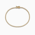 The 14K Yellow Gold Diamond Tennis Bracelet 1.30 TCW features a single row of round white diamonds in prong settings, displayed in a circular shape on a white background.