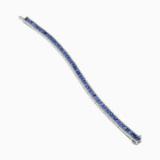 The Nahla Siri 14K White Gold Tanzanite and Diamond Tennis Bracelet features square blue tanzanites bordered by sparkling diamonds, elegantly set in a classic tennis bracelet design.