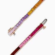 The Watercolors 14K Rose Gold Multi Sapphire Bracelet features square-cut sapphires in a gradient rainbow design, elegantly set in a thin rose gold band and shown against a white background.