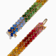 The Watercolors 14K Yellow Gold Multi Sapphire Double Lined Baguette Bracelet features baguette-cut sapphires in a diagonal rainbow gradient, elegantly arranged around the band and shown on a white background.
