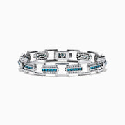 The Men's 14K White Gold Blue and White Diamond Link Bracelet features rectangular links with blue and white diamonds in geometric patterns set against a white gold background.