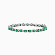 The Brasilica 14K White Gold Emerald and Diamond Tennis Bracelet features alternating round green emeralds and clear diamonds, beautifully displayed on a white background.