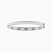 The 925 Sterling Silver and Diamond Bangle features a sleek design with repeating square sections, each set with sparkling diamond-like clear stones.