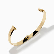 The 14K Yellow Gold Oval with Hinge Bracelet features a polished, smooth surface and classic oval hinge design, displayed against a plain white background.