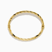 A 14K Yellow Gold Hammered Hinge Bangle featuring a textured finish, showcased on a white background.