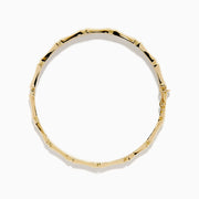 The 14K Yellow Gold Bamboo Hinge Bangle features a polished, bamboo-inspired texture and is photographed on a white background.