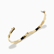 The 14K Yellow Gold Bamboo Hinge Bangle features a polished, bamboo-inspired texture and is photographed on a white background.