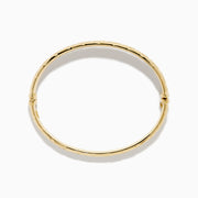 The 14K Yellow Gold Textured Hinge Bracelet features a shiny finish and a geometric diamond-patterned texture around its outer surface, shown on a white background.